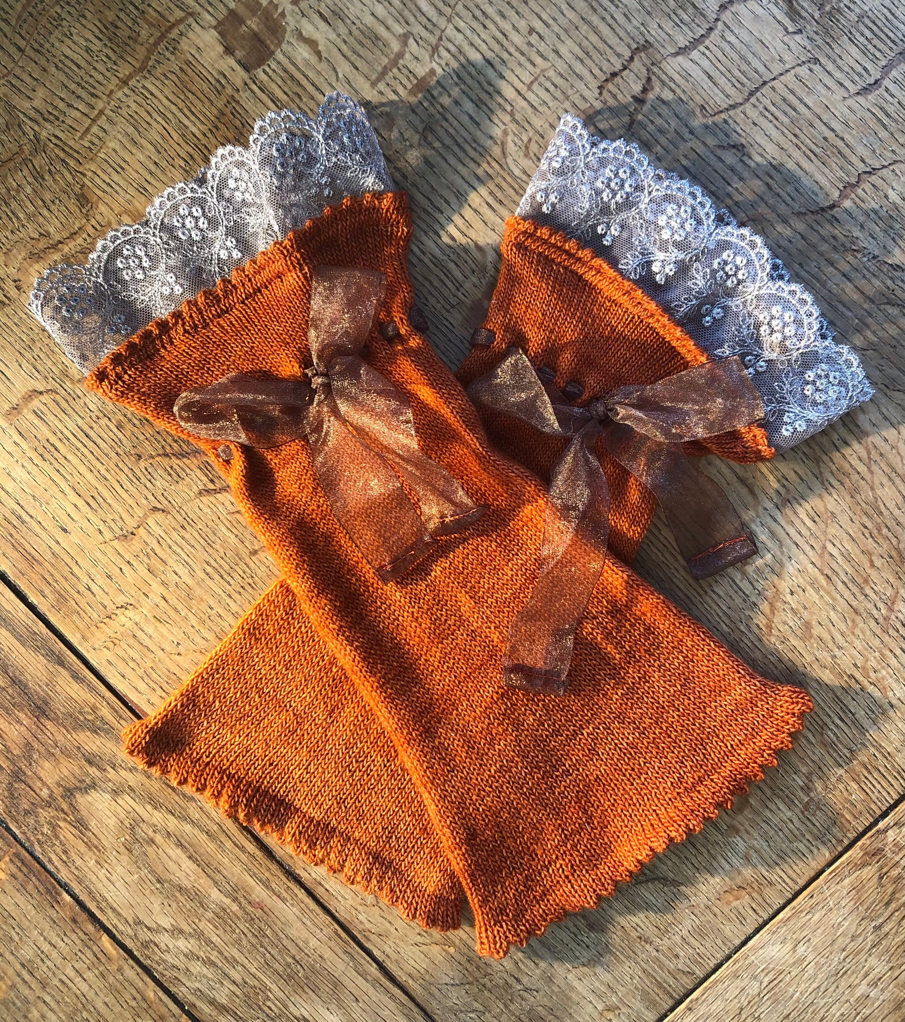 Burnt orange merino hand cranked wrist warmers.